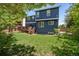 Two-story home with a deck and a spacious lawn at 104 Willowick Cir, Highlands Ranch, CO 80129