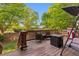 Backyard deck featuring wicker furniture, grill, and an umbrella table with overhead canopy at 104 Willowick Cir, Highlands Ranch, CO 80129
