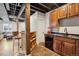 Finished basement bar area featuring a sink, cabinets, wine rack, and rustic wood accents at 104 Willowick Cir, Highlands Ranch, CO 80129