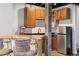 Basement bar featuring wooden accents, a small refrigerator, cabinets, and seating at 104 Willowick Cir, Highlands Ranch, CO 80129