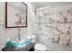 Modern bathroom with glass bowl sink, marble-style tile, and glass enclosed shower at 104 Willowick Cir, Highlands Ranch, CO 80129