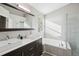 Bright bathroom with double vanity, soaking tub, and a separate glass-enclosed shower at 104 Willowick Cir, Highlands Ranch, CO 80129