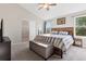 Spacious bedroom with vaulted ceilings, an accent wall, and a large window at 104 Willowick Cir, Highlands Ranch, CO 80129