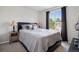 Comfortable bedroom with a neutral palette, large window, and side table at 104 Willowick Cir, Highlands Ranch, CO 80129