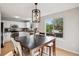 Cozy dining area with a dark wooden table, seating for six, and a window overlooking the backyard at 104 Willowick Cir, Highlands Ranch, CO 80129