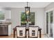 Cozy dining room with modern chandelier and natural light, with backyard view at 104 Willowick Cir, Highlands Ranch, CO 80129