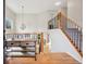 Inviting entryway features wood floors, staircase with iron railings, and vaulted ceilings with modern light fixture at 104 Willowick Cir, Highlands Ranch, CO 80129