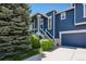 Charming two-story home with blue siding, white trim, well-manicured lawn, and an attached two-car garage at 104 Willowick Cir, Highlands Ranch, CO 80129