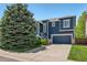 Charming two-story home with a covered porch, well-manicured landscaping, and an attached garage at 104 Willowick Cir, Highlands Ranch, CO 80129