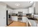 Bright kitchen featuring white cabinets, stainless steel appliances, and light countertops at 104 Willowick Cir, Highlands Ranch, CO 80129