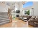 Bright living room with hardwood floors, a cozy fireplace, and large windows providing plenty of natural light at 104 Willowick Cir, Highlands Ranch, CO 80129