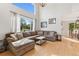 Spacious living room with hardwood floors, a comfortable sectional sofa, and a view of the outdoor landscape at 104 Willowick Cir, Highlands Ranch, CO 80129