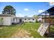 Expansive backyard featuring a patio seating area, a climbing play structure, and lush lawn at 986 S Jersey St, Denver, CO 80224