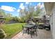 Beautiful backyard with a lush lawn, patio seating, and mature trees providing shade at 986 S Jersey St, Denver, CO 80224