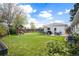 Spacious backyard with a well-maintained lawn, playground, and patio seating area at 986 S Jersey St, Denver, CO 80224