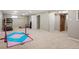 Large basement area with carpet, equipment, and ample space for activities at 986 S Jersey St, Denver, CO 80224