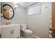 Cozy bathroom features white vanity, modern fixtures, toilet and mirror at 986 S Jersey St, Denver, CO 80224