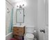 Bathroom featuring a shower-tub combo, blue shower curtain, wood vanity, and tiled walls at 986 S Jersey St, Denver, CO 80224