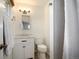 Bathroom featuring white vanity, toilet, and shower with curtain at 986 S Jersey St, Denver, CO 80224