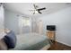 Comfortable bedroom with soft blue walls, ceiling fan, and natural light at 986 S Jersey St, Denver, CO 80224