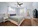 Primary bedroom with blue walls, ceiling fan, and wood floors at 986 S Jersey St, Denver, CO 80224