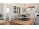Bright dining room with fireplace, modern chandelier, and natural light at 986 S Jersey St, Denver, CO 80224