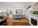 Bright dining room with fireplace, modern chandelier, and view to adjacent kitchen at 986 S Jersey St, Denver, CO 80224