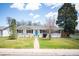 Charming ranch-style home with a well-maintained lawn and inviting turquoise front door at 986 S Jersey St, Denver, CO 80224