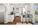 Updated kitchen with white cabinets, stainless steel appliances, and an eat-in peninsula at 986 S Jersey St, Denver, CO 80224