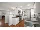 Modern kitchen with stainless steel appliances, white cabinetry, and hardwood floors at 986 S Jersey St, Denver, CO 80224