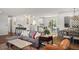 Open-concept living area with adjacent kitchen and dining space with lots of natural light at 986 S Jersey St, Denver, CO 80224