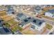 Neighborhood aerial view of homes with lush green lawns, paved driveways, and mature trees at 915 N Waterloo Ct, Aurora, CO 80018