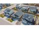 An aerial view highlighting a suburban home featuring a well-kept lawn, solar panels and a 2-car garage at 915 N Waterloo Ct, Aurora, CO 80018