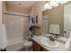 Bright bathroom features vanity, mirror, shower and tub combination at 915 N Waterloo Ct, Aurora, CO 80018