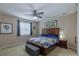 Comfortable bedroom with a wooden bed frame, ceiling fan, and neutral walls creating a relaxing atmosphere at 915 N Waterloo Ct, Aurora, CO 80018
