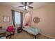 Charming bedroom features a canopy bed, a ceiling fan and comfortable beige carpet at 915 N Waterloo Ct, Aurora, CO 80018