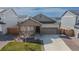 Charming single-Gathering home featuring a covered porch, two-car garage, and well-maintained landscaping at 915 N Waterloo Ct, Aurora, CO 80018