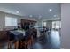 Open-concept kitchen featuring dark cabinetry, granite countertops, stainless steel appliances, and an island with seating at 915 N Waterloo Ct, Aurora, CO 80018