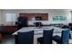 Bright open kitchen with a granite island, dark cabinets, and stainless-steel appliances, with an adjacent living space at 915 N Waterloo Ct, Aurora, CO 80018