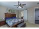 A spacious main bedroom featuring a sliding barn door leading to the en-suite bath, and comfy decor at 915 N Waterloo Ct, Aurora, CO 80018