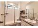 Bathroom with shower, vanity, and built-in shelving at 9308 Inca Dove Cir, Littleton, CO 80125