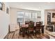Dining room with wood table and chairs, and wood-look floors at 9308 Inca Dove Cir, Littleton, CO 80125
