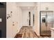 Bright entryway with wood-look floors and stainless steel refrigerator at 9308 Inca Dove Cir, Littleton, CO 80125