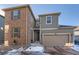 Two-story home with brick and siding exterior, attached garage, and landscaping at 9308 Inca Dove Cir, Littleton, CO 80125