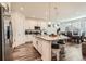 Modern kitchen with white cabinets, granite island and stainless steel appliances at 9308 Inca Dove Cir, Littleton, CO 80125