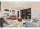 Open living space with sectional sofa, TV, fireplace, and kitchen views at 9308 Inca Dove Cir, Littleton, CO 80125