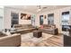 Spacious living room with sectional sofa, large TV, and fireplace at 9308 Inca Dove Cir, Littleton, CO 80125