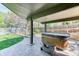 Spacious covered back patio includes a hot tub and stamped concrete, perfect for relaxation and entertaining at 13830 Silverton Dr, Broomfield, CO 80020