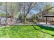 Well-maintained backyard with a swing, bench, and manicured lawn provides a serene outdoor retreat at 13830 Silverton Dr, Broomfield, CO 80020