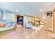 Finished basement with recreation space, stone accent wall, pinball machine, and luxury vinyl flooring at 13830 Silverton Dr, Broomfield, CO 80020